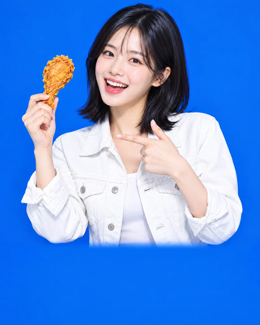 흰 데님 재킷을 입은 여성이 닭다리를 가리키며 웃는 모습
